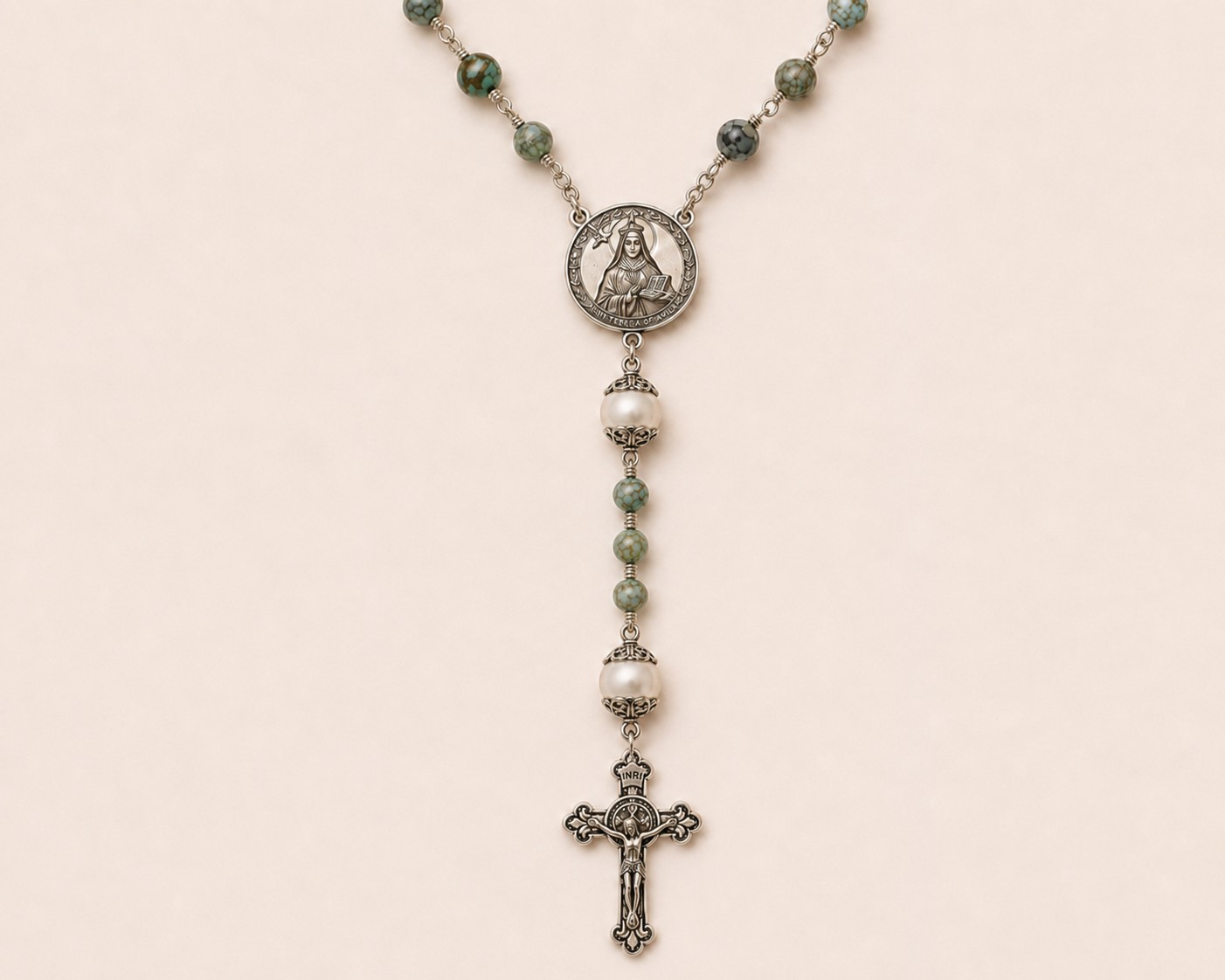 St. Teresa of Ávila Rosary on a parchment-toned background